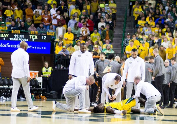 February 12 2022: Baylor Bears head coach SCOTT DREW talks to Baylor Bears forward Jonathan Tchamwa Tchatchoua (23) who is injured during the 1st half of the NCAA, College League, USA Basketball game between the Texas Longhorns and Baylor Bears at Ferrell Center in Waco, Texas. CSM Waco US - ZUMAc04_ 20220212_zaf_c04_103 Copyright: xMatthewxLynchx