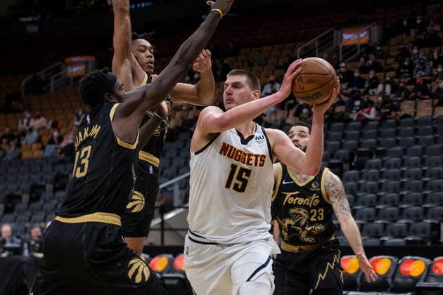 February 12, 2022, Toronto, ON, CAN: Denver Nuggets Nikola Jokic (15) looks to pass as Toronto Raptors Pascal Siakam, left, Scottie Barnes (centre left) and Fred VanVleet defend during second half NBA, Basketball Herren, USA basketball action in Toronto on Saturday, February 12, 2022. Nikola Jokic; Pascal Siakam; Scottie Barnes; Fred VanVleet - ZUMAc35_ 20220212_zaf_c35_299 Copyright: xChrisxYoungx