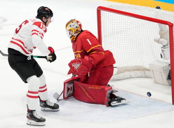 February 13, 2022, Beijing, ON, China: Canada forward Adam Tambellini (15) scores on China goaltender Yongli Ouban (1) during first period men s Ice hockey, Eishockey action at the Beijing Olympic Winter games, Winterspiele,Spiele, Summer games in Beijing, Sunday, Feb. 13, 2022. Canada v. China Men s Olympic Ice Hockey - ZUMAc35_ 20220213_zaf_c35_026 Copyright: xRyanxRemiorzx