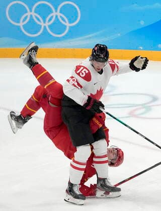 February 13, 2022, Beijing, ON, China: China defender Kailiaosi Jieke (7) gets upended over Canada forward Adam Tambellini (15) during first period men s Ice hockey, Eishockey action at the Beijing Olympic Winter games, Winterspiele,Spiele, Summer games in Beijing, Sunday, Feb. 13, 2022. Adam Tambellini, Taile Wang - ZUMAc35_ 20220213_zaf_c35_035 Copyright: xRyanxRemiorzx