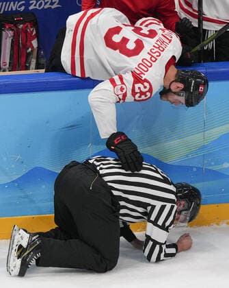 (220213) -- BEIJING, Feb. 13, 2022 -- Tyler Wotherspoon (top) of Canada checks on the referee hit by a puck the Ice hockey, Eishockey men s preliminary round Group A match between China and Canada at National Indoor Stadium in Beijing, capital of China, Feb. 13, 2022. ) (BEIJING2022)CHINA-BEIJING-OLYMPIC Winter games, Winterspiele,Spiele, Summer games ICE HOCKEY-MEN S PRELIMINARY-CHN VS CAN(CN) DuxYu 