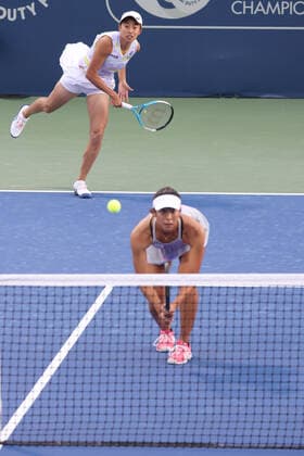 Zhang Shuai, CHN (cap, full white), and Ena Shibahara, JPN, during first round doubles of 2022 Dubai Championships in Dubai, 14 02 2022; -
