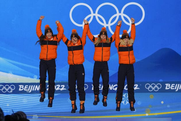 Members of Team Netherlands gold medalists Selma Poutsma, Suzanne Schulting, Yara van Kerkhof, and Xandra Velzeboer leap onto the podium during the medals ceremony for the Women s Short Track 3000m Relay at the Beijing 2022 Winter Olympics on Monday, February 14, 2022.  OLY20220214311 PaulxHanna