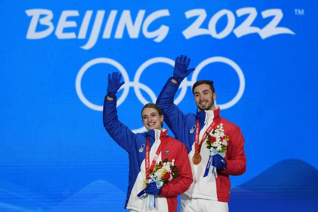 Gold medallists Gabriella Papadakis and Guillaume Cizeron of France wave with their medals during the medal ceremony for the Figure skating, Eiskunstlauf Ice Dance competition at the Beijing 2022 Winter Olympics on Monday, February 14, 2022.  OLY20220214318 PaulxHanna
