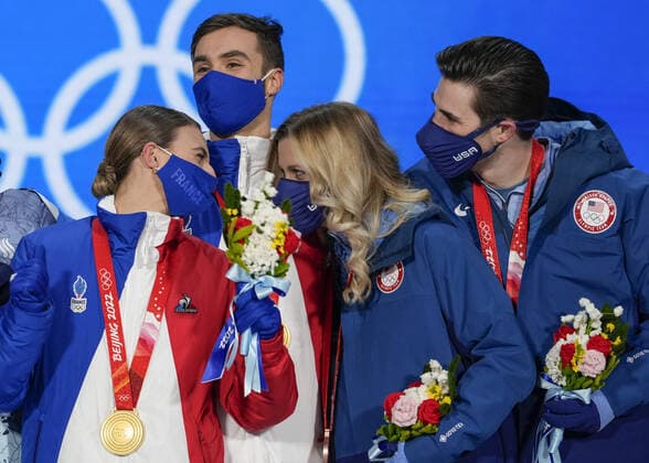 Gold medallists Gabriella Papadakis and Guillaume Cizeron of France smile next to Bronze medallists Zachary Donohue and Madison Hubbell of the United States during the medal ceremony for the Figure skating, Eiskunstlauf Ice Dance competition at the Beijing 2022 Winter Olympics on Monday, February 14, 2022.  OLY20220214322 PaulxHanna