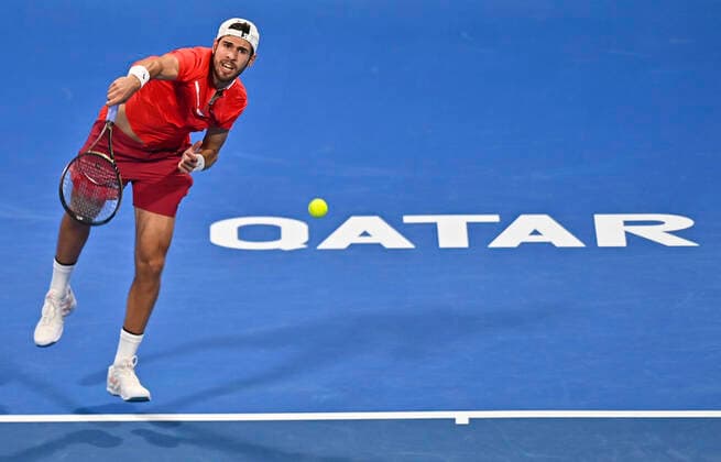 (220215) -- DOHA, Feb. 15, 2022 -- Karen Khachanov of Russia serves during the first round of ATP, Tennis Herren Qatar Open tennis match against Mackenzie McDonald of the United States in Doha, capital of Qatar, Feb. 14, 2022. (Photo by Xinhua) (SP)QATAR-DOHA-TENNIS-ATP QATAR OPEN Nikku 