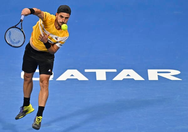 (220215) -- DOHA, Feb. 15, 2022 -- Thomas Fabbiano of Italy serves to Botic van de Zandschulp of the Netherlands during the first round of ATP, Tennis Herren Qatar Open tennis match in Doha, capital of Qatar, Feb. 14, 2022. (Photo by Xinhua) (SP)QATAR-DOHA-TENNIS-ATP QATAR OPEN Nikku 