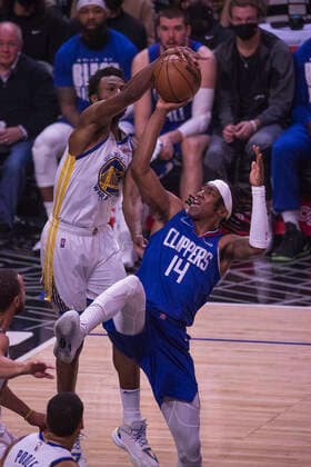 February 14, 2022, Los Angeles, California, USA: Terance Mann 14 of the Los Angeles Clippers attempts to shoot the ball as Andrew Wiggins 22 of the Golden State Warriors blocks him during their NBA, Basketball Herren, USA game on Monday February 14, 2022 at Crypto.com Arena in Los Angeles, California. Clippers defeat Warriors, 119-104. ARIANA RUIZ PI Los Angeles USA - ZUMAp124 20220214_zaa_p124_002 Copyright: xArianaxRuizx