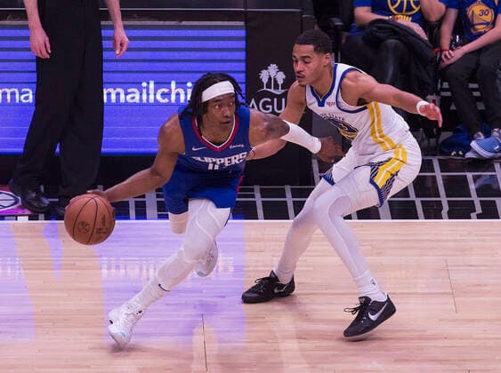 February 14, 2022, Los Angeles, California, USA: Terance Mann 14 of the Los Angeles Clippers takes the ball as Jordan Poole 3 of the Golden State Warriors is on defense during their NBA, Basketball Herren, USA game on Monday February 14, 2022 at Crypto.com Arena in Los Angeles, California. Clippers defeat Warriors, 119-104. ARIANA RUIZ PI Los Angeles USA - ZUMAp124 20220214_zaa_p124_014 Copyright: xArianaxRuizx