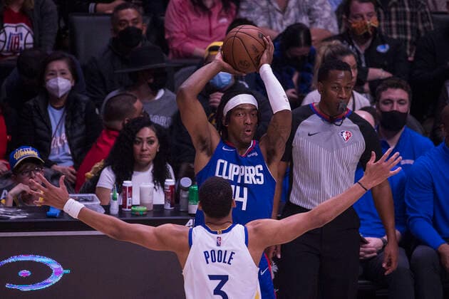 February 14, 2022, Los Angeles, California, USA: Terance Mann 14 of the Los Angeles Clippers passes the ball as Jordan Poole 3 of the Golden State Warriors blocks him during their NBA, Basketball Herren, USA game on Monday February 14, 2022 at Crypto.com Arena in Los Angeles, California. Clippers defeat Warriors, 119-104. ARIANA RUIZ PI Los Angeles USA - ZUMAp124 20220214_zaa_p124_019 Copyright: xArianaxRuizx