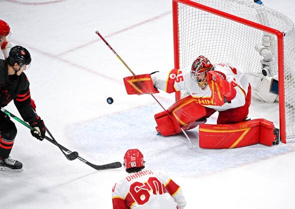 (220215) -- BEIJING, Feb. 15, 2022 -- Goalkeeper Shimisi Jieruimi (C) of China makes a save during the Ice hockey, Eishockey men s qualification play-off of Beijing 2022 Winter Olympics between Canada and China at Wukesong Sports Centre, in Beijing, capital of China, Feb. 15, 2022. ) (BEIJING2022)CHINA-BEIJING-OLYMPIC Winter games, Winterspiele,Spiele, Summer games ICE HOCKEY-MEN S QUALIFICATION PLAY-OFF-CAN VS CHN (CN) LixZiheng