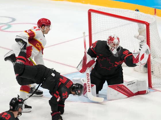 February 15, 2022, Beijing, China: Team Canada goaltender Matt Tomkins (90) makes a save as Team China forward An Jian (47) looks on and Canada s Mat Robinson (37) falls during third period men s qualification round hockey action at the Beijing Winter Olympics in Beijing, China, on Tuesday, Feb. 15, 2022. Canada News - February 15, 2022  - ZUMAc35_ 20220215_zaf_c35_124 Copyright: xRyanxRemiorzx