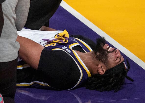 February 16, 2022, Los Angeles, California, USA: Anthony Davis 3 of the Los Angeles Lakers goes down in pain after injuring his ankle on an offensive rebound in the second quarter of their NBA, Basketball Herren, USA home game against the Utah Jazz on Wednesday February 16, 2022 at Crypto.com Arena in Los Angeles, California. PI Los Angeles USA - ZUMAp124 20220216_zaa_p124_051 Copyright: xJAVIERxROJASx