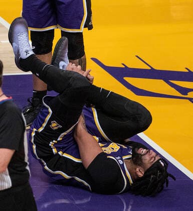 February 16, 2022, Los Angeles, California, USA: Anthony Davis 3 of the Los Angeles Lakers goes down in pain after injuring his ankle on an offensive rebound in the second quarter of their NBA, Basketball Herren, USA home game against the Utah Jazz on Wednesday February 16, 2022 at Crypto.com Arena in Los Angeles, California. PI Los Angeles USA - ZUMAp124 20220216_zaa_p124_048 Copyright: xJAVIERxROJASx