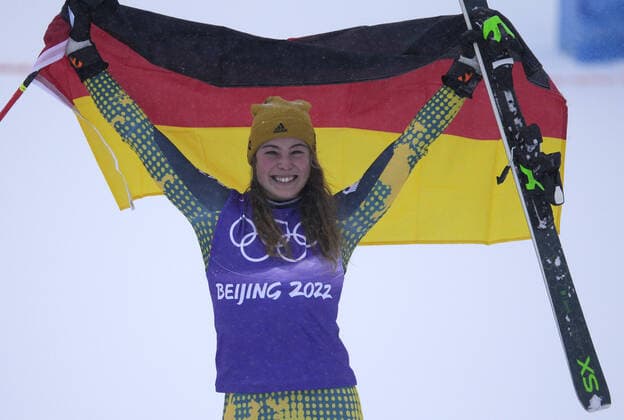 Bronze medalist Daniela Maier of Germany stands on the podium with her national flag after the Women s Freestyle Skiing Ski Cross final at the 2022 Beijing Winter Olympics in Zhangjiakou, China on Thursday, February 17, 2022. Sandra Naeslund of Sweden won the gold medal and Marielle Thompson of Canada won the silver medal.  OLY20220217675 BOBxSTRONG