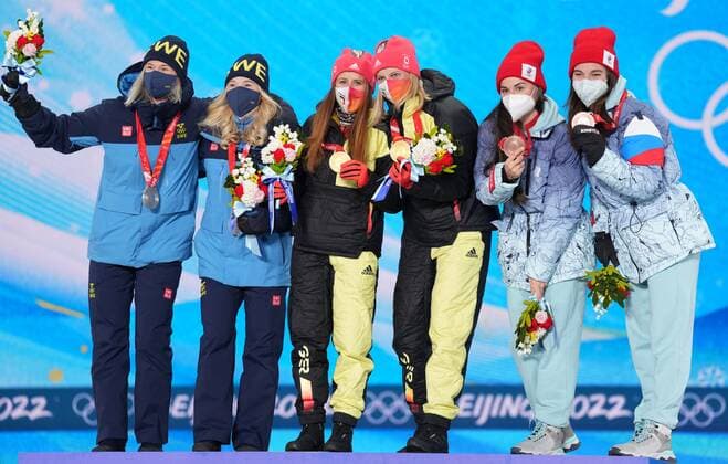 China Olympics 2022 Medal Ceremony 8118041 17.02.2022 From left, silver medalists Sweden s Maja Dahlqvist and Jonna Sundling, gold medalists Germany s Katharina Hennig and Victoria Carl and bronze medalists Russian Olympic Committee s Yulia Stupak and Natalia Nepryaeva celebrate on the podium during an award ceremony for the women s cross-country team sprint classic event during the Beijing 2022 Winter Olympic Games, Olympische Spiele, Olympia, OS at the Medals Plaza in Zhangjiakou, China. Pavel Bednyakov Sputnik Zhangjiakou China  Copyright: xPavelxBednyakovx