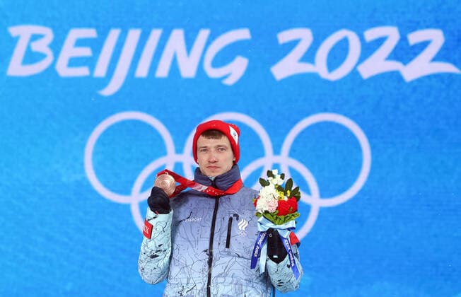 ZHANGJIAKOU, CHINA - FEBRUARY 17, 2022: Bronze medallist Ilya Burov of Team ROC celebrates during the victory ceremony for the men s freestyle skiing aerials, at the Medal Plaza, at the 2022 Winter Olympic Games, Olympische Spiele, Olympia, OS Stanislav Krasilnikov TASS  TS123D4B