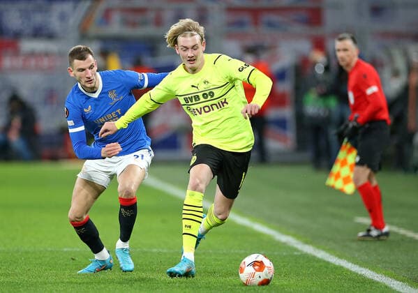 17.02.2022, Fussball UEFA Europa League 2021 2022, Play-Off, Borussia Dortmund - Glasgow Rangers, im Signal-Iduna-Park Dortmund. (L-R) Borna Barisic (Glasgow Rangers) gegen Julian Brandt (Borussia Dortmund)