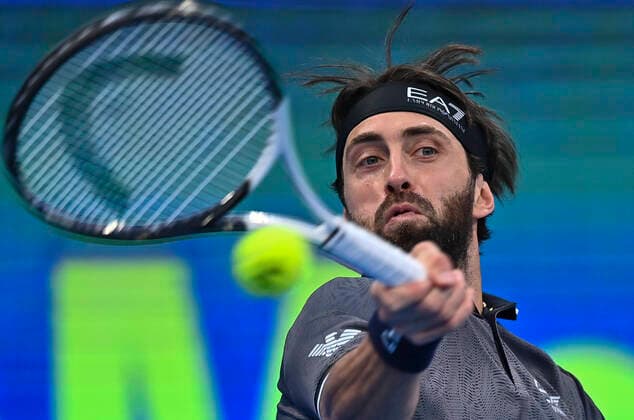 (220218) -- DOHA, Feb. 18, 2022 -- Nikoloz Basilashvili of Georgia returns the ball during the quarterfinal of ATP, Tennis Herren Qatar Open Tennis match against Marton Fucsovics of Hungary at International Tennis Complex in Doha, capital of Qatar, Feb. 17, 2022. (Photo by Xinhua) (SP)QATAR-DOHA-TENNIS-ATP QATAR OPEN-QUARTERFINAL Nikku 