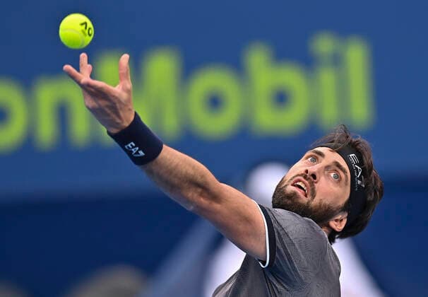 (220218) -- DOHA, Feb. 18, 2022 -- Nikoloz Basilashvili of Georgia serves during the quarterfinal of ATP, Tennis Herren Qatar Open Tennis match against Marton Fucsovics of Hungary at International Tennis Complex in Doha, capital of Qatar, Feb. 17, 2022. (Photo by Xinhua) (SP)QATAR-DOHA-TENNIS-ATP QATAR OPEN-QUARTERFINAL Nikku 