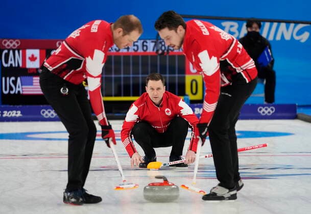 February 18, 2022, Beijing, China: Canada skip Brad Gushue, centre, watches his shot as Geoff Walker, left, and Brett Gallant sweep during men s bronze medal curling action against the United States at the 2022 Winter Olympics in Beijing on Friday, Feb. 18, 2022. Canada News - February 18, 2022  - ZUMAc35_ 20220218_zaf_c35_044 Copyright: xRyanxRemiorzx
