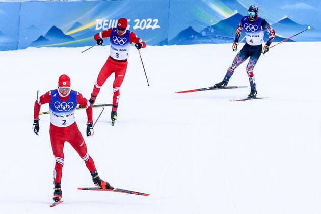 ZHANGJIAKOU, CHINA - FEBRUARY 19, 2022: Skiers Alexander Bolshunov of Team ROC, Ivan Yakimushkin of Team ROC, and Simen Hegstad Krueger (L-R) of Norway compete to win gold, silver, and bronze respectively in the men s 30km cross-country skiing mass start race during the Beijing 2022 Winter Olympic Games, Olympische Spiele, Olympia, OS at the Zhangjiakou National Cross-Country Skiing Centre. The men s 50km cross-country skiing mass start race has been shortened to 30km due to weather conditions. Stanislav Krasilnikov TASS  TS1243BB