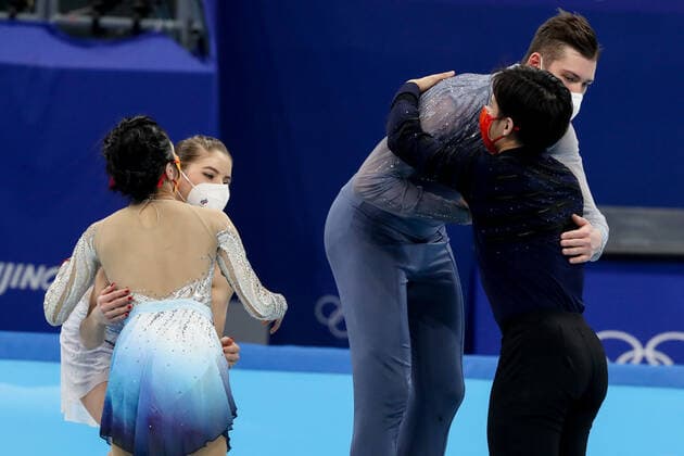 BEIJING, CHINA - FEBRUARY 19, 2022: Silver medalists Yevgenia Tarasova and Vladimir Morozov of Team ROC (back) and gold medalists Jin Yang and Peng Cheng of China (front) hug at a flower ceremony for the pair skating at the 2022 Winter Olympic Games, Olympische Spiele, Olympia, OS at the Capital Indoor Stadium. Valery Sharifulin TASS  TS124592