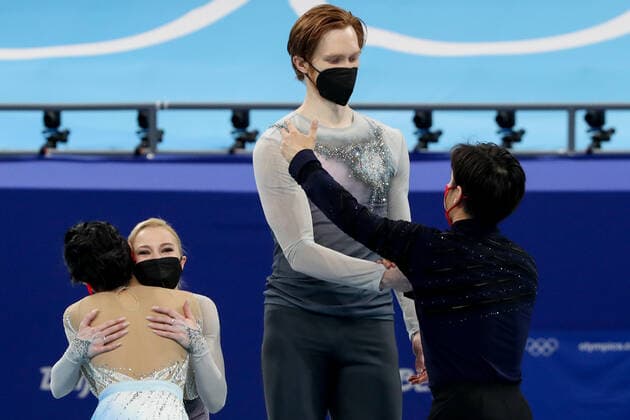 BEIJING, CHINA - FEBRUARY 19, 2022: Silver medalists Yevgenia Tarasova and Vladimir Morozov of Team ROC (back) and gold medalists Jin Yang and Peng Cheng of China (front) hug at a flower ceremony for the pair skating at the 2022 Winter Olympic Games, Olympische Spiele, Olympia, OS at the Capital Indoor Stadium. Valery Sharifulin TASS  TS124593