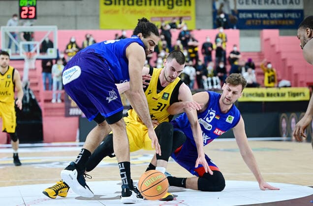 Basketball 2. Bundesliga 2021 2022 32. Spieltag in der Paul Horn Arena Tigers Tuebingen - Phoenix Hagen 19.02.2022 Daniel Keppeler (Mitte, Tigers) gegen Philip Daubner (re, Hagen) und Javon Baumann (li, Hagen)