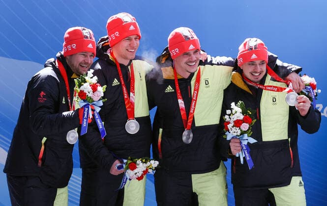 BEIJING, CHINA - FEBRUARY 20, 2022: Silver medalists Johannes Lochner, Florian Bauer, Christopher Weber, and Christian Rasp of Germany at a flower ceremony for the 4-man bobsleigh at the 2022 Winter Olympic Games, Olympische Spiele, Olympia, OS at the Yanqing National Sliding Centre. Anton Novoderezhkin TASS  TS1247E5