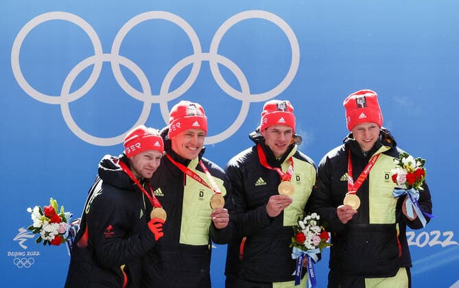 BEIJING, CHINA - FEBRUARY 20, 2022: Gold medalists Francesco Friedrich, Thorsten Margis, Candy Bauer, and Alexander Schueller of Germany at a flower ceremony for the 4-man bobsleigh at the 2022 Winter Olympic Games, Olympische Spiele, Olympia, OS at the Yanqing National Sliding Centre. Anton Novoderezhkin TASS  TS1247EB