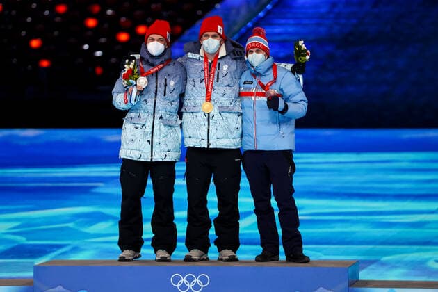 BEIJING, CHINA â€“ FEBRUARY 20, 2022: Silver medallist Ivan Yakimushkin of Team ROC, gold medallist Alexander Bolshunov of Team ROC, and bronze medallist Simen Hegstad Krueger (L-R) of Norway pose at a victory ceremony for the men s 30km cross-country skiing mass start race at the closing ceremony of the Beijing 2022 Winter Olympic Games, Olympische Spiele, Olympia, OS at the National Stadium (also known as the Bird s Nest). The men s 50km cross-country skiing mass start race has been shortened to 30km due to weather conditions. Valery Sharifulin TASS  TS124976