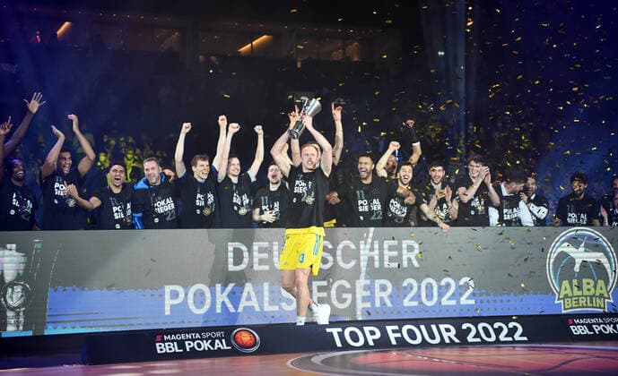 Basketball, Herren, Saison 2021 2022, MagentaSport BBL Pokal, Top Four (Finale), Hakro Merlins Crailsheim - Alba Berlin, Luke Sikma (Alba Berlin) hebt den Pokal in die Luft, 20.02. 2022, Copyright: xSebastianxRäppold MatthiasxKochx
