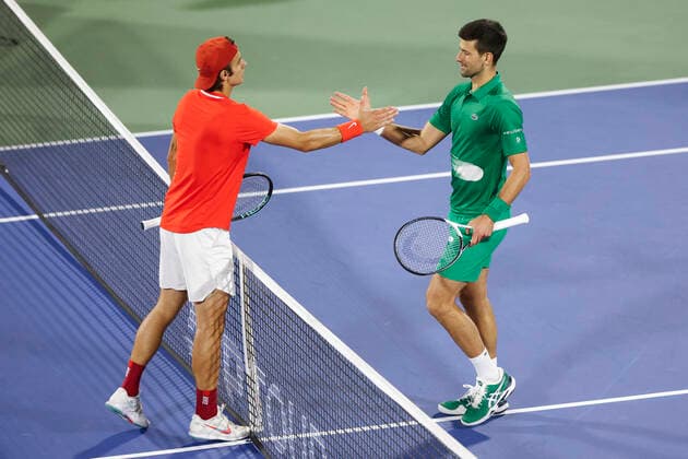 Lorenzo Musetti gratuliert dem Sieger Novak Djokovic (SRB) Tennis - Dubai Duty Free Tennis Championships - ATP, Tennis Herren - Dubai Duty Free Tennis Stadium - Dubai - - United Arab Emirates - 21 February 2022. Copyright: xJuergenxHasenkopfx