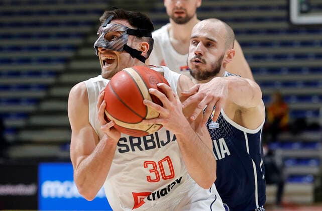 (220226) -- BELGRADE, Feb. 26, 2022 -- Serbia s Aleksa Avramovic (L) vies with Slovakia s Simon Krajcovic during their FIBA Basketball World Cup 2023 qualifying match in Belgrade, Serbia on Feb. 25, 2022. (Photo by Xinhua) (SP)SERBIA-BELGRADE-BASKETBALL-FIBA-SERBIA VS SLOVAKIA PredragxMilosavljevic 