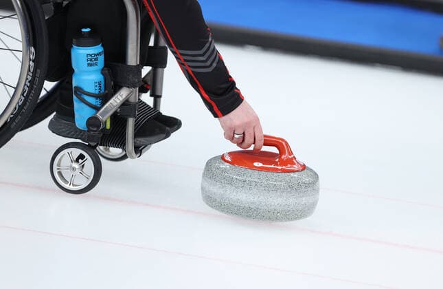(220310) -- BEIJING, March 10, 2022 -- Jon Thurston of Canada pushes the stone during the Wheelchair Curling Round Robin Match between Canada and Norway of Beijing 2022 Winter Paralympics at National Aquatics Centre in Beijing, capital of China, on March 10, 2022. ) (SP)CHINA-BEIJING-WINTER PARALYMPICS-WHEELCHAIR CURLING-ROUND ROBIN SESSION-CAN VS NOR(CN) DuxXiaoyi 