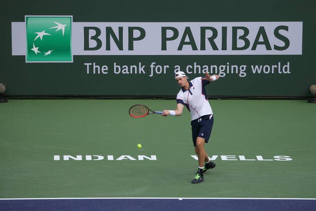 INDIAN WELLS, CA - MARCH 13: John Isner (USA) hits a forehand during the BNP Paribas Open on March 12, 2022 at Indian Wells Tennis Garden in Indian Wells, CA. (Photo by George Walker Icon Sportswire) TENNIS: MAR 13 BNP Paribas Open Icon220313001