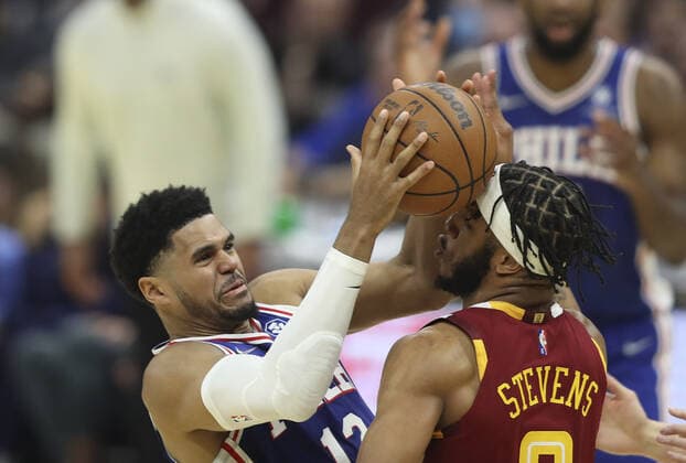 Philadelphia 76ers Tobias Harris (12) losses control of the ball while defended by Cleveland Cavaliers Lamar Stevens (8) at Rocket Mortgage Field House in Cleveland, Ohio on Wednesday, March 16, 2022.  CLE202203161101 AARONxJOSEFCZYK