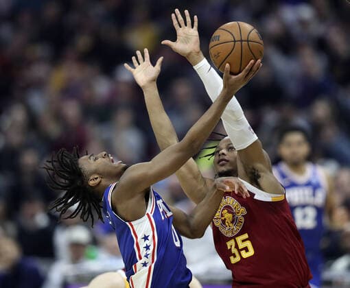 Philadelphia 76ers Tyrese Maxey (0) puts up a shot while defended by Cleveland Cavaliers Isaac Okoro (35) at Rocket Mortgage Field House in Cleveland, Ohio on Wednesday, March 16, 2022.  CLE202203161118 AARONxJOSEFCZYK