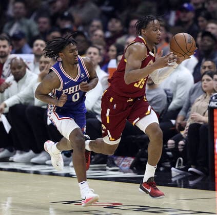 Cleveland Cavaliers Isaac Okoro (35) grabs a loose ball in front of Philadelphia 76ers Tyrese Maxey (0) at Rocket Mortgage Field House in Cleveland, Ohio on Wednesday, March 16, 2022.  CLE20220316115 AARONxJOSEFCZYK