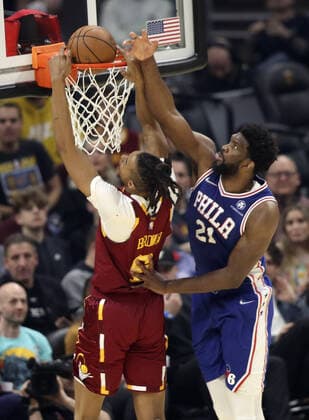 Cleveland Cavaliers Moses Brown (6) dunks over Philadelphia 76ers Joel Embiid (21) at Rocket Mortgage Field House in Cleveland, Ohio on Wednesday, March 16, 2022.  CLE20220316126 AARONxJOSEFCZYK