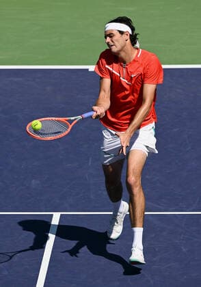 INDIAN WELLS, CA - MARCH 16: Taylor Fritz of the United States returns the ball near the net during a tennis match played on March 16, 2022 at the BNP Paribas Open at the Indian Wells Tennis Garden in Indian Wells, CA. (Photo by John Cordes Icon Sportswire) TENNIS: MAR 16 BNP Paribas Open Icon506220316054