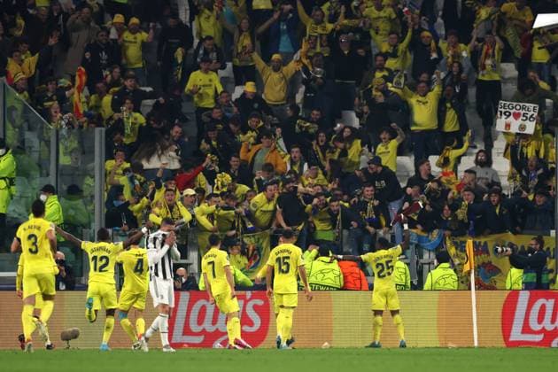 Turin, Italy, 16th March 2022. Mattia De Sciglio of Juventus reacts as Pau Torres of Villarreal CF celebrates with team mates after scoring to give the side a 2-0 lead during the UEFA Champions League match at Allianz Stadium, Turin. Picture credit should read: Jonathan Moscrop Sportimage EDITORIAL USE ONLY. No use with unauthorised audio, video, data, fixture lists, club league logos or live services. Online in-match use limited to 120 images, no video emulation. No use in betting, games or single club league player publications. SPI-1579-0113