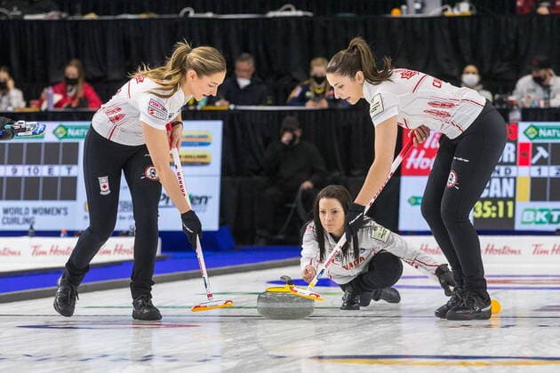March 20, 2022, Prince George, BC, CANADA: Canada skip Kerri Einarson throws a stone while lead Briane Meilleur, left, and second Shannon Birchard prepare to sweep at CN Centre on Sunday afternoon at the Womens World Curling in Prince George, B.C., Sunday, March 20, 2022. Canada News - March 20, 2022 - ZUMAc35_ 20220320_zaf_c35_079 Copyright: xJamesxDoylex