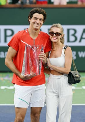 INDIAN WELLS, CA - MARCH 20: Taylor Fritz of the United States holds the championship trophy with girlfriend Morgan Riddle after winning a finals tennis match at the BNP Paribas Open played on March 20, 2022 at the Indian Wells Ennis Garden in Indian Wells, CA. (Photo by John Cordes Icon Sportswire) TENNIS: MAR 20 BNP Paribas Open Men s Final Icon506220320229
