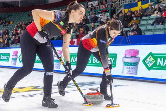 March 22, 2022, Prince George, BC, Canada: Team Germany lead Analena Jentsch, left, and third Emira Abbes sweep in front of a stone at CN Centre on Tuesday afternoon during at the Women s World Curling in Prince George, B.C., on Tuesday, March 22, 2022. Canada News - March 22, 2022 - ZUMAc35_ 20220322_zaf_c35_149 Copyright: xJamesxDoylex