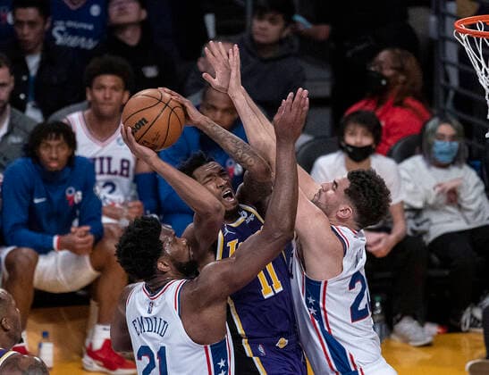 March 23, 2022, Los Angeles, California, USA: Malik Monk 11 of the Los Angeles Lakers as blocked by Philadelphia 76ers defenders as he goes to the basket during their NBA, Basketball Herren, USA game on Wednesday March 23, 2022 at Crypto.com Arena in Los Angeles, California. Lakers lose to 76ers, 121-126. PI Los Angeles USA - ZUMAp124 20220323_zaa_p124_022 Copyright: xJAVIERxROJASx