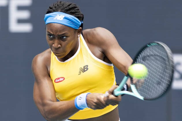 Cori Gauff from the USA returns a two handed backhand shot back to Qiang Wang from China at the Miami Open in the Hard Rock Stadium in Miami Gardens, Florida, on Friday, March 25, 2022. Gauff defeated Wang 7-5, 6-4.  MIA20220325109 GARYxIxROTHSTEIN