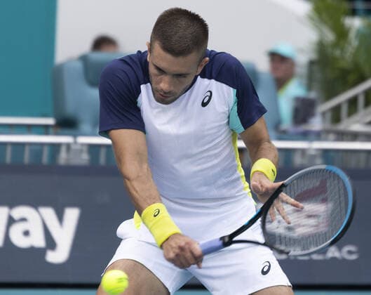 Borna Coric from Croatia returns a forehand shot back to Alexander Zverev from Germany at the Miami Open in the Hard Rock Stadium in Miami Gardens, Florida, on Friday, March 25, 2022. Zverev defeated Coric 6-4, 3-6, 6-4 in three sets.  MIA20220325115 GARYxIxROTHSTEIN
