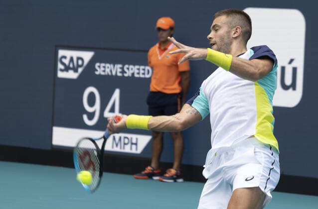 Borna Coric from Croatia returns a forehand shot to Alexander Zverev from Germany at the Miami Open in the Hard Rock Stadium in Miami Gardens, Florida, on Friday, March 25, 2022. Zverev defeated Coric 6-4, 3-6, 6-4 in three sets.  MIA20220325118 GARYxIxROTHSTEIN